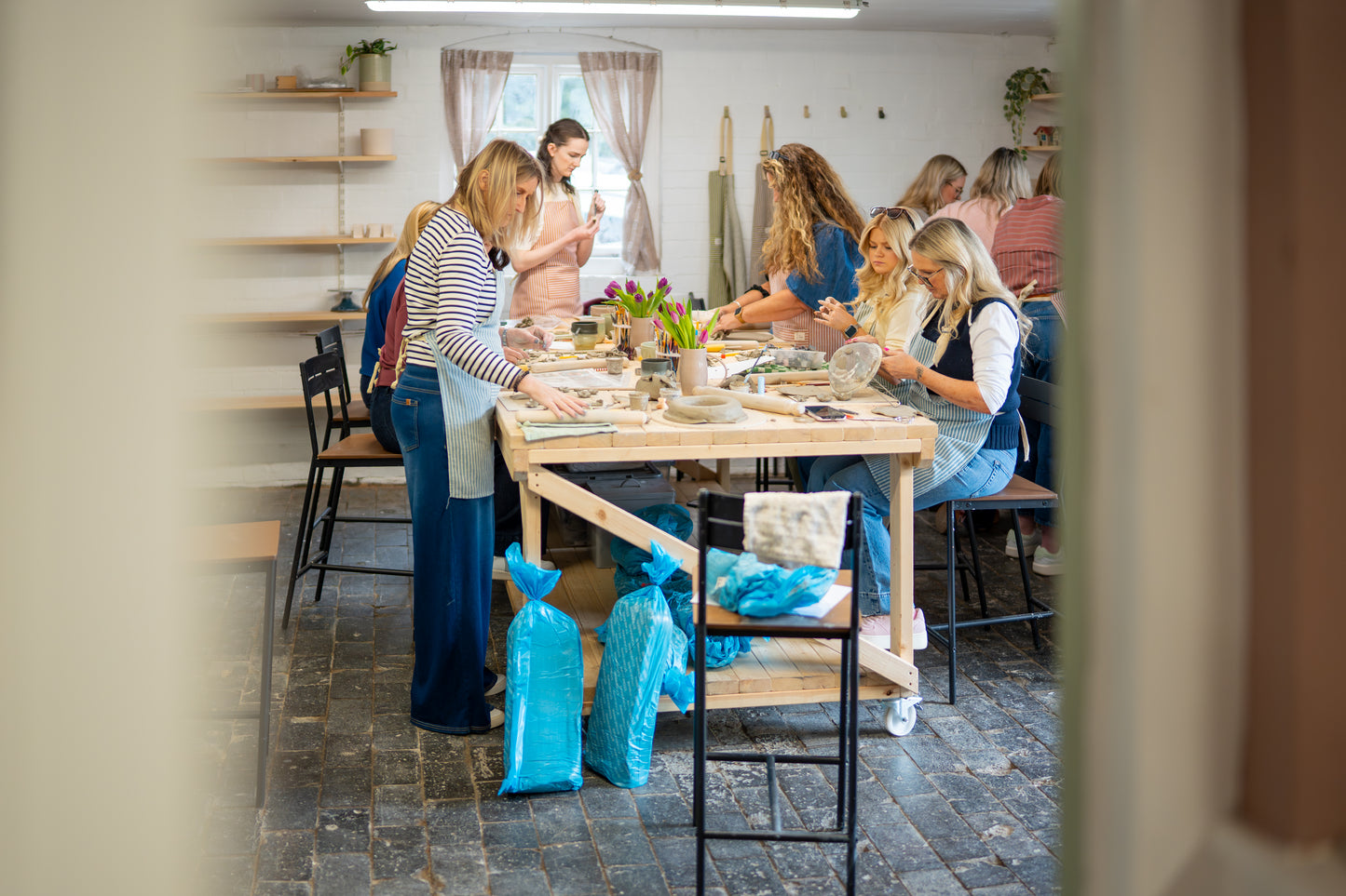 Group of people working together at a table in a workshop setting.